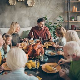 Family having a large holiday dinner celebration.