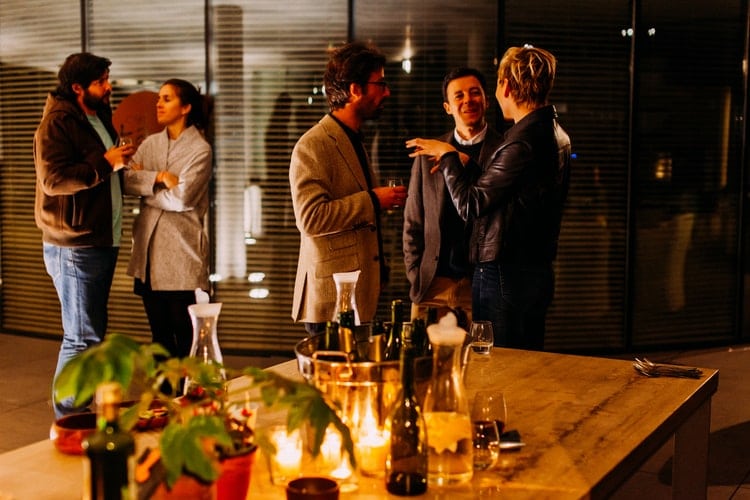 Adults socializing at a dinner party.