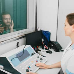 Audiologist administering a hearing test