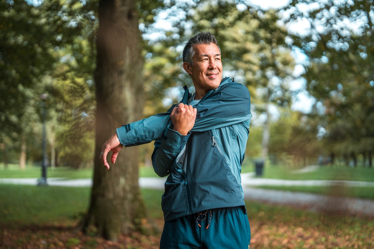 Senior man stretching at the park