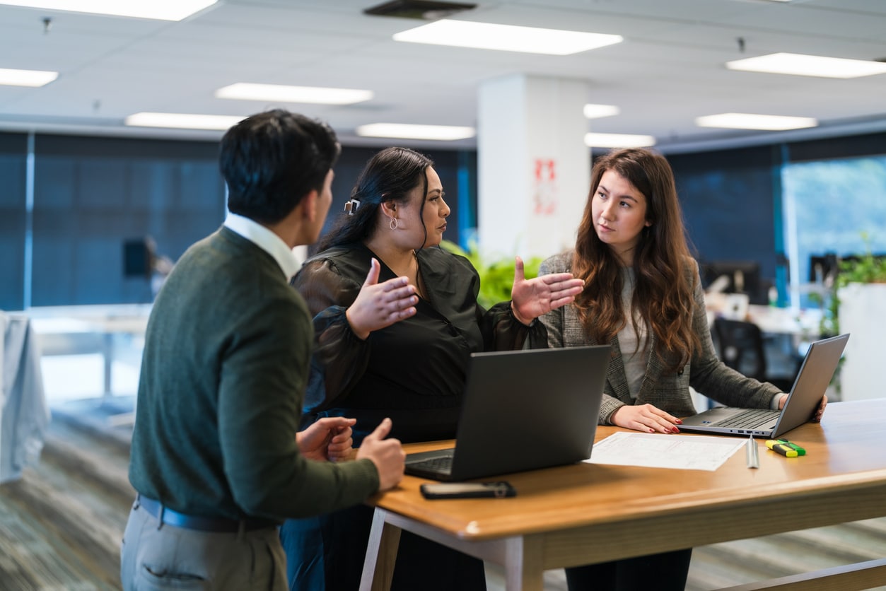 Three people talking in an office