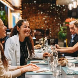 Friends laughing and enjoying dinner together