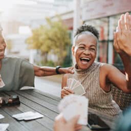 Three senior women playing cards.