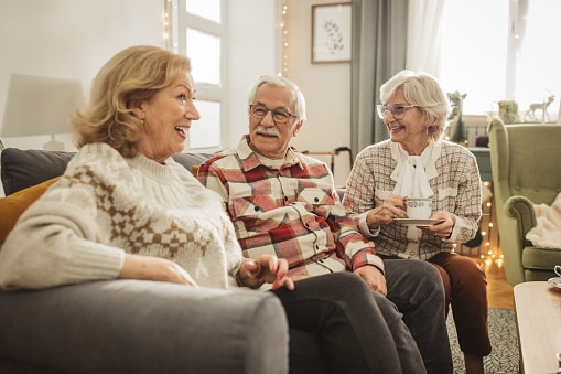 Three senior women playing cards.