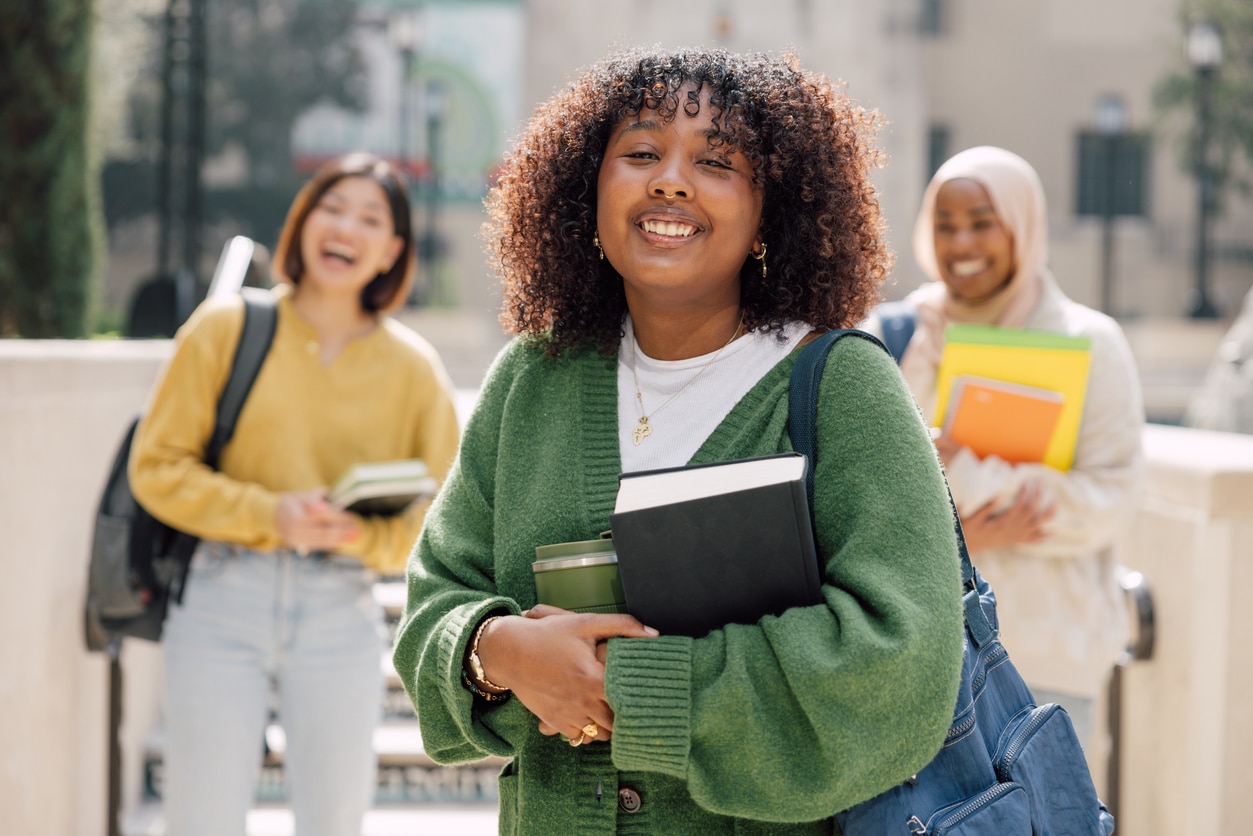 Smiling teenagers on their first day at college.